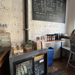 a woman sitting at a table in a coffee shop a woman sitting at a table in a coffee shop