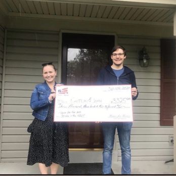 G & K Group - My husband and I in front of our brand new home with our $3325 check from Homes for Heroes. - Real Estate Agents Near Me G & K Group - My husband and I in front of our brand new home with our $3325 check from Homes for Heroes. - Real Estate Agents Near Me
