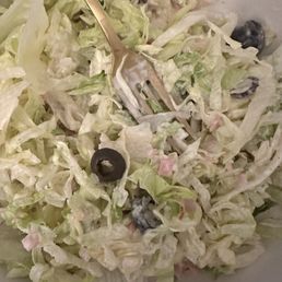 Shredded iceberg lettuce salad with with some olives Shredded iceberg lettuce salad with with some olives