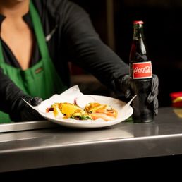Serving bar where your food comes out . They call out your number with order. And you pick up your food .