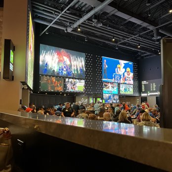 DraftKings Sportsbook - a crowd of people sitting at a bar - Sports Bars Near Me - Waterloo, New York
