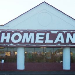the front of a store with cars parked in front of it
