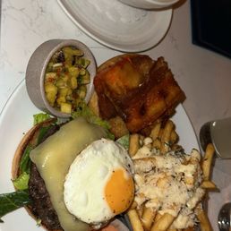 que mas burger with pineapple salsa on the side on the left is the unusual squash soup that has an amazing garlic flavor que mas burger with pineapple salsa on the side on the left is the unusual squash soup that has an amazing garlic flavor