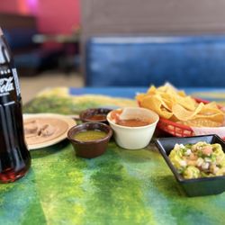 El Cuñado  Mexican Cuisine - Great guacamole, corn, chips, salsa, the green sauce is very hot, the red sauce is even hotter, beans to the side for dip.