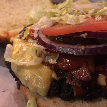Rocks Lakeview - Smackdown Burger * Smashed griddle burger with Merkt's cheddar, bacon, spicy chipotle ketchup, lettuce, tomato, onion and bread & butter pic - Sports Bars Near Me - Chicago, Illinois