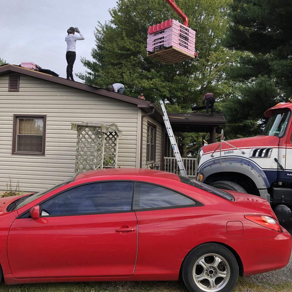 Red Moon Expert - a red car being lifted by a crane - Roofing Near Me - Evansville, Indiana Red Moon Expert - a red car being lifted by a crane - Roofing Near Me - Evansville, Indiana