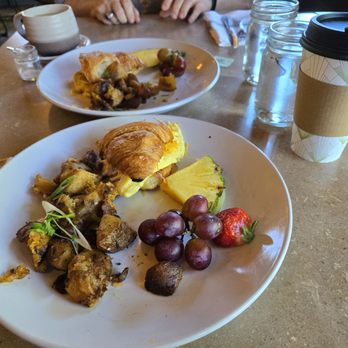 Bistro 76 Cafe & Catering - Shared croissant breakfast sandwich fruit and potatoes - Breakfast & Brunch Near Me - Edmonds, Washington Bistro 76 Cafe & Catering - Shared croissant breakfast sandwich fruit and potatoes - Breakfast & Brunch Near Me - Edmonds, Washington