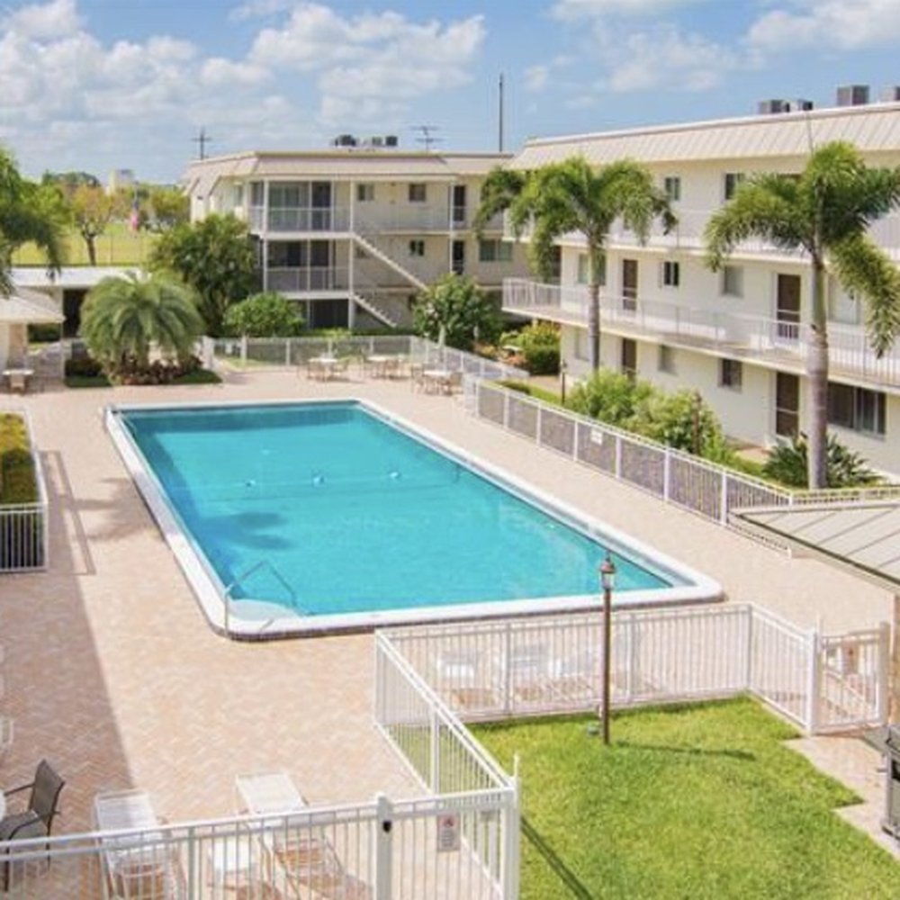 Central Gardens - Wonderfully large community pool surrounded by lush landscaping - Property Management Near Me - Naples, Florida