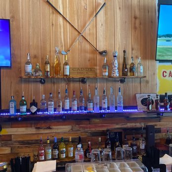 Caddy Shack - a bar with liquor bottles and a television - New American Near Me - Spring, Texas