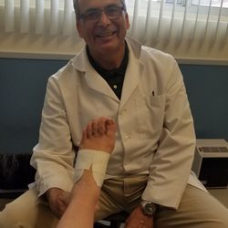 Desantis Nicholas DPM - Dr DeSantis showing me how to tape my foot for support.