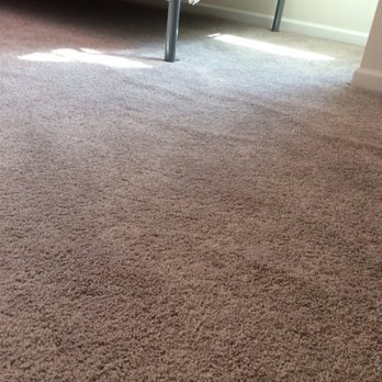 Captain's Carpets - a bedroom with a bed and a desk - Flooring Near Me - Little Egg Harbor, New Jersey