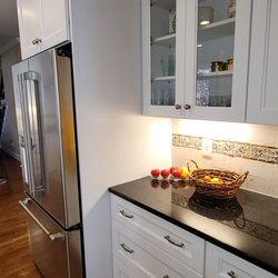 Kitchen and Bath by Zeus - white shaker cabinets , under cabinets lights.