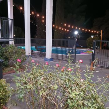 Days Inn by Wyndham Red Bluff - Pool area with string lights that halfway work - Hotels Near Me - Red Bluff, California