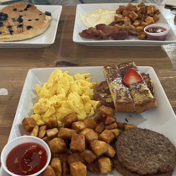 Sizzle & Brew - The Big Sizzle, one with eggs over medium and a blueberry pancake, the other with scrambled and French toast. - Breakfast & Brunch Near Me - Tomball, Texas