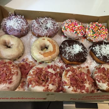 Duck Donuts - Left to right: blueberry icing, strawberry w/ sprinkles, vanilla with sprinkles, lemon icing, chocolate icing with coconut, Maple bacon - Donuts Near Me - Rockville, Maryland Duck Donuts - Left to right: blueberry icing, strawberry w/ sprinkles, vanilla with sprinkles, lemon icing, chocolate icing with coconut, Maple bacon - Donuts Near Me - Rockville, Maryland