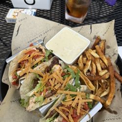 Fore Seasons Clubhouse Bar & Grill - Smash Burger Tacos , hand cut fries and queso.