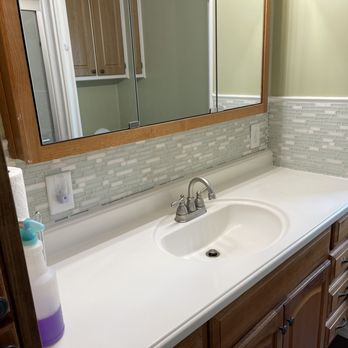 Mettscapes - a bathroom with a sink and mirror - General Contractors Near Me Mettscapes - a bathroom with a sink and mirror - General Contractors Near Me