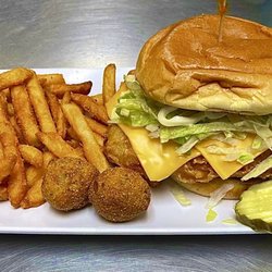 John Wayne's Pub & Eatery - The "Fish Sandwich", with a side of seasoned Fries and Hushpuppies.