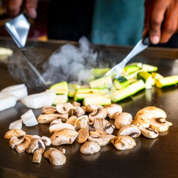 Tomo - a chef chopping mushrooms and zucchini - Sushi Bars Near Me - New Albany, Indiana Tomo - a chef chopping mushrooms and zucchini - Sushi Bars Near Me - New Albany, Indiana