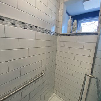 House Matters Renovations - a shower with a glass door - General Contractors Near Me