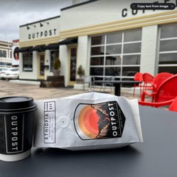 Bag of whole beans and a chai latte to go. Bag of whole beans and a chai latte to go.
