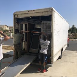 Errol and Mike fitting unfastening the straps to unload our belongings. It's a miracle they were able to fit all of it in the truck.