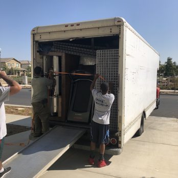 2Man Moving Services - Errol and Mike fitting unfastening the straps to unload our belongings. It's a miracle they were able to fit all of it in the truck. - Movers Near Me