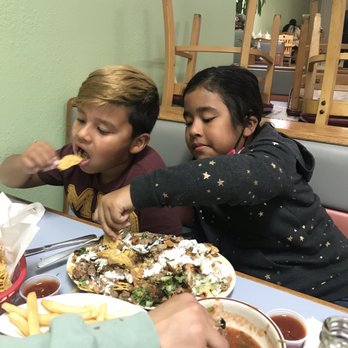 Las Brisas de Acapulco - Kids having super nachos de asada y pollo - New American Near Me - San Francisco, California Las Brisas de Acapulco - Kids having super nachos de asada y pollo - New American Near Me - San Francisco, California