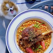 Photo of Jeninni Kitchen + Wine Bar - Pacific Grove, CA, United States. Crispy Lamb Shank w/ garbanzo beans, harissa broth, brown butter, poached radishes, herbs | $36 (dog-friendly patio!)