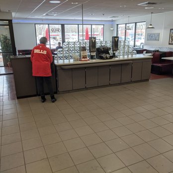 Tom Wahl's Fairport - a man standing at a counter - Burgers Near Me - Fairport, New York