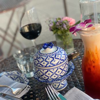 Thai BBQ House - a glass of red wine and a teapot on a table - Salad Near Me - Petaluma, California Thai BBQ House - a glass of red wine and a teapot on a table - Salad Near Me - Petaluma, California