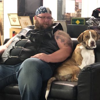 Good Karma Cigar - a man sitting on a couch with his dog - Tobacco Shops Near Me - Lubbock, Texas Good Karma Cigar - a man sitting on a couch with his dog - Tobacco Shops Near Me - Lubbock, Texas
