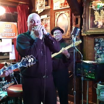 Sand Bar - a man and a woman singing and playing guitar - Dive Bars Near Me - Saugatuck, Michigan