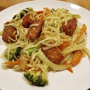 Photo of Village Natural - New York, NY, United States. Curry noodles with tempeh. They brought the spice when I asked for very hot, but gave me Sriracha just in case :-)
