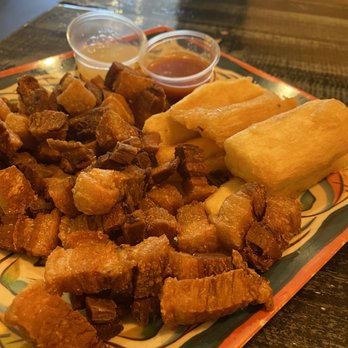 The Latin Pig Cuban Restaurant - Chicarrones and yuca fritas with in house mojito sauce and hot sauce - Cuban Near Me - Plano, Texas The Latin Pig Cuban Restaurant - Chicarrones and yuca fritas with in house mojito sauce and hot sauce - Cuban Near Me - Plano, Texas