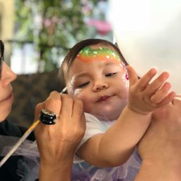 Patiently painting on my wriggly one year old!