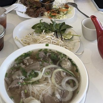 Saigon Bistro - Beef pho and pork and fried egg dish with hot green tea - Vietnamese Near Me - Lakeland, Florida Saigon Bistro - Beef pho and pork and fried egg dish with hot green tea - Vietnamese Near Me - Lakeland, Florida