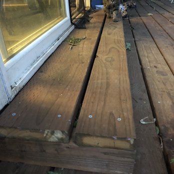 Marcus Construction & Development - a cat sitting on a deck - General Contractors Near Me