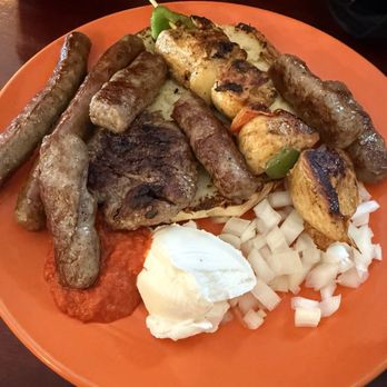 Euro Grill - Combo plate of meat. Holding the bread to see meat - Mediterranean Near Me - Santa Clara, California