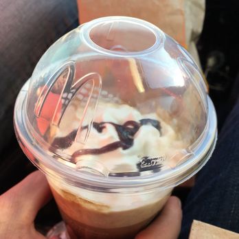 McDonald's - a person holding a cup of coffee - Burgers Near Me - Alva, Oklahoma
