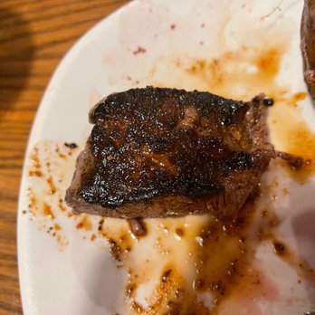 Outback Steakhouse - This photo is a burned medium rare steak - Steakhouses Near Me - Rogers, Arkansas