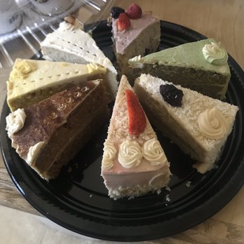 The Grain Cafe - Starting from the "white" cake and moving clockwise are: Tres leches, berries, green tea, coconut, strawberry, lemon, maca, and lemon. - Vegan Near Me - Long Beach, California
