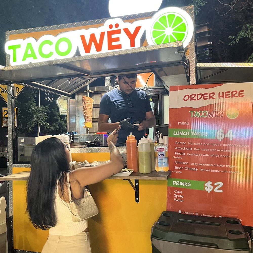 a woman ordering a drink a woman ordering a drink