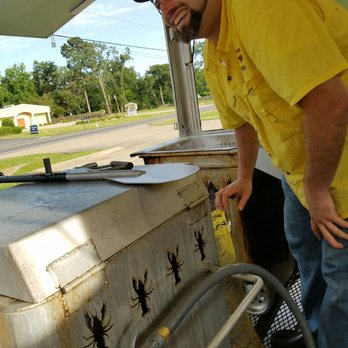 Chuck Wagon Crawfish - a man in a yellow shirt - Cajun/Creole Near Me - Shreveport, Louisiana