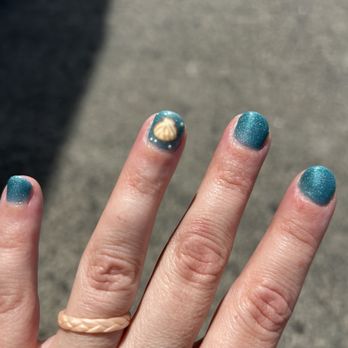 Salem Nail Bar - Blue painted finger nails with a crudely done upside down sea shell on the index finger - Nail Salons Near Me - Salem, Massachusetts Salem Nail Bar - Blue painted finger nails with a crudely done upside down sea shell on the index finger - Nail Salons Near Me - Salem, Massachusetts