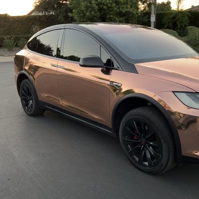 Rose gold chrome wrap + chrome delete + pillar delete - The client wanted his Model X to stand out from every other one on the road and chose to go with rose gold. Avery Dennison rose gold chrome and gloss black was applied to the entire car along with painted badges. The client also requested a ceramic coating be applied to help protect the mirror finish of the chrome, making it easier to clean and maintain. This was one of our more memorable projects and still have yet to see anything like it on the road! Rose gold chrome wrap + chrome delete + pillar delete - The client wanted his Model X to stand out from every other one on the road and chose to go with rose gold. Avery Dennison rose gold chrome and gloss black was applied to the entire car along with painted badges. The client also requested a ceramic coating be applied to help protect the mirror finish of the chrome, making it easier to clean and maintain. This was one of our more memorable projects and still have yet to see anything like it on the road!