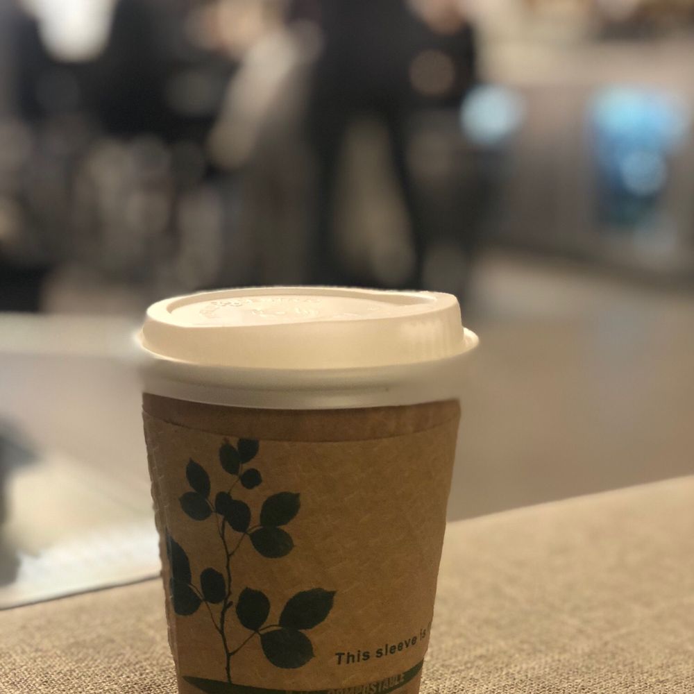 a cup of coffee on a table a cup of coffee on a table