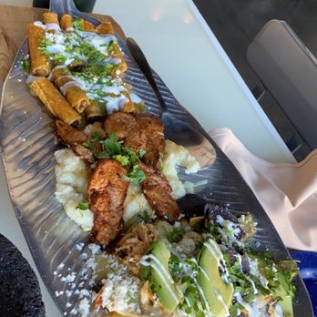 Sol Y Luna - Three small plates together. Shredded Beef Flautas, Puntas de Puerco, and Chicken Chilaquiles - Latin American Near Me - Mountain Brook, Alabama Sol Y Luna - Three small plates together. Shredded Beef Flautas, Puntas de Puerco, and Chicken Chilaquiles - Latin American Near Me - Mountain Brook, Alabama