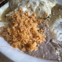 Half of chili relleno burrito, rice, refried beans, I demolished the first half of plate Half of chili relleno burrito, rice, refried beans, I demolished the first half of plate