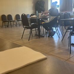 Utility lady eating on the dining area
